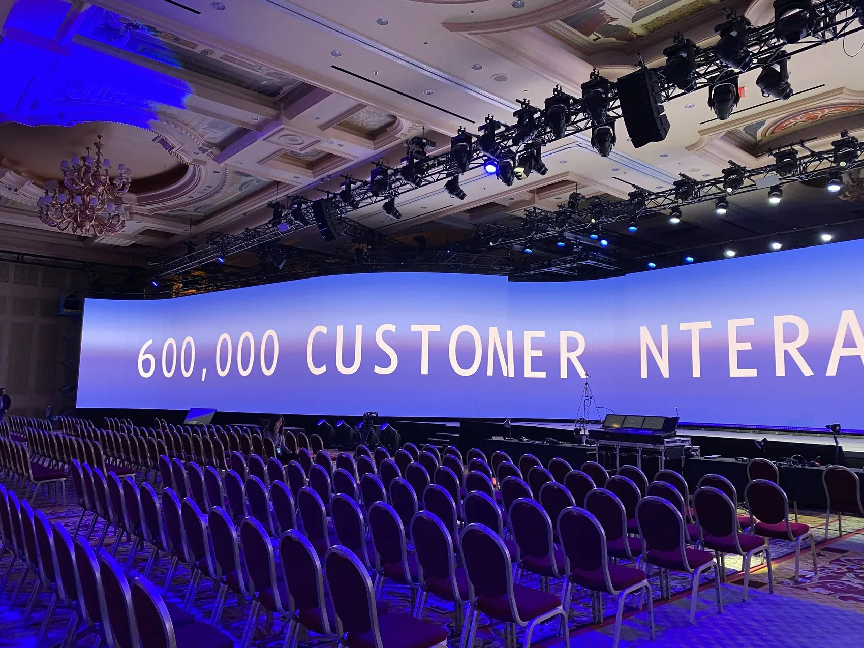 A statistic across the curved screen: 600,000 customer interactions