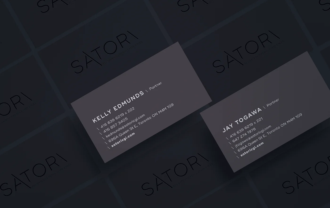 Satori business cards for the two partners, laid over a tiled pattern of the wordmark