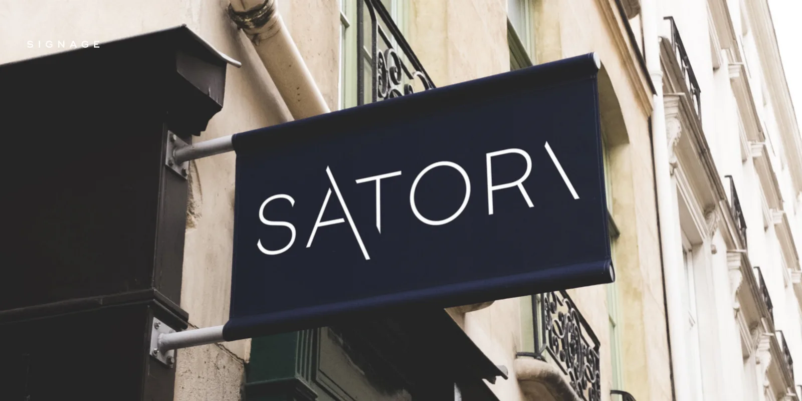 Satori blade sign mounted on a building exterior